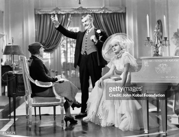 Jean Harlow is Hollywood sex goddess Lola Burns and Frank Morgan is her father, Pop Burns, in 'Bombshell', directed by Victor Fleming. Mary Forbes...