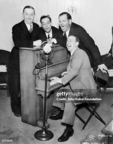 American silent screen comedian and actor Buster Keaton with fellow comedians Jimmy Durante , Stan Laurel and Oliver Hardy .