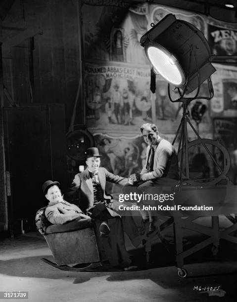 Stan Laurel and Oliver Hardy with their long term producer, Hal Roach .