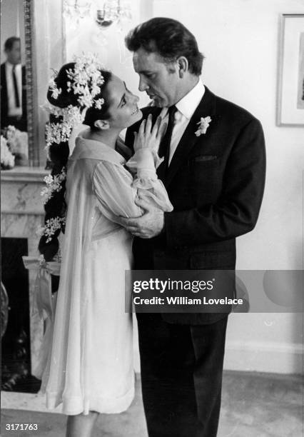 British film stars Elizabeth Taylor and Richard Burton at their first wedding in Montreal, Canada. They married twice, but both marriages ended in...