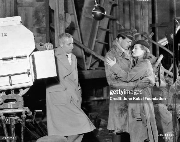 Director Howard Hawks watches his two romantic leads, Joan Crawford and Gary Cooper on the set of their latest film, the World War I romance 'Today...