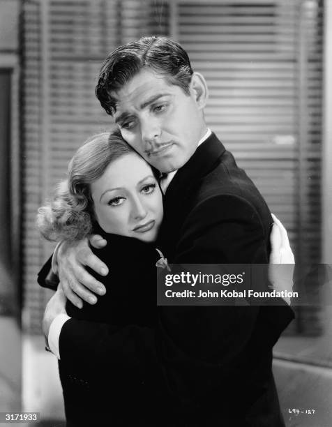 Frequent co-stars Joan Crawford and Clark Gable share a desperate embrace in the musical 'Dancing Lady', directed by Robert Z Leonard.