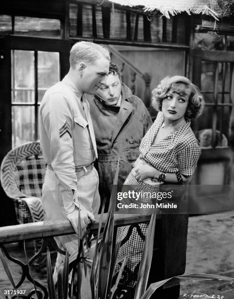 Russian-born director Lewis Milestone with actors Joan Crawford and William Gargan , who play prostitute Sadie Thompson and Sergeant O'Hara in his...