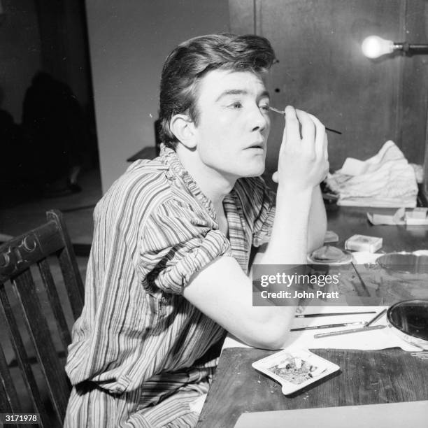 Film and stage actor Albert Finney applying his own make-up before a performance in London.