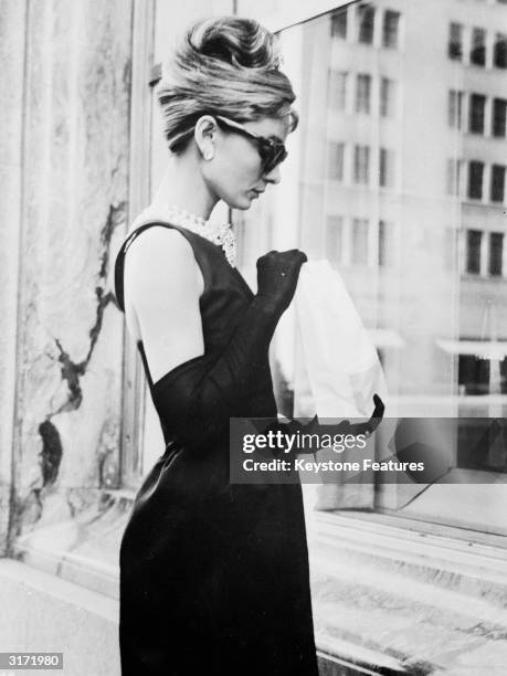 Audrey Hepburn stops for lunch on Fifth Avenue in New York during location filming for 'Breakfast At Tiffany's', directed by Blake Edwards in which...