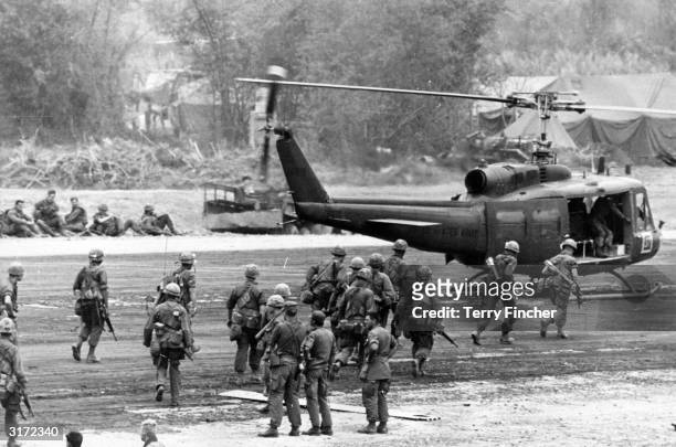 Air cavalry' moves toward a U.S. Army assault helicopter, which will take part in securing a landing zone two miles from Khe Sanh during the Vietnam...