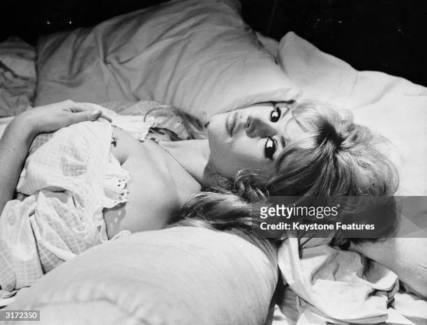 Sultry French actress Brigitte Bardot in bed.