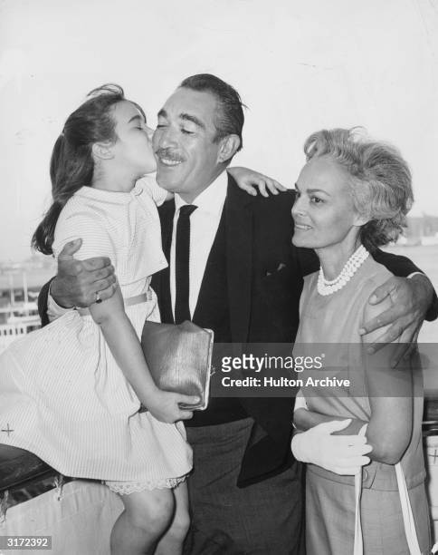 Mexican-born actor Anthony Quinn hugs his wife, American actor Katherine DeMille , and their daughter Valentina upon his return from Marrakech aboard...