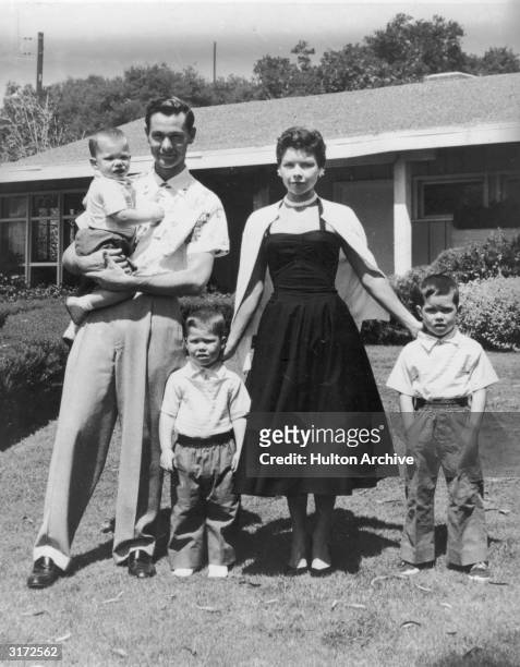 Full-length portrait of American comedian and television show host Johnny Carson, his wife Jody Wolcott, and their three sons standing in the front...