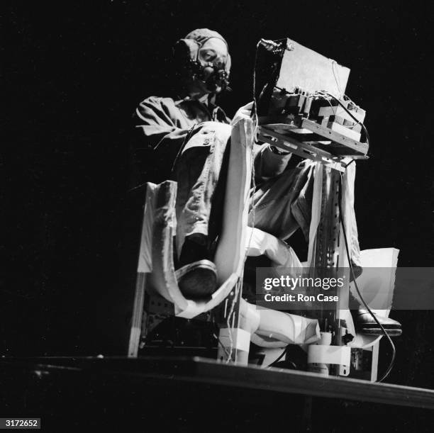 Doctor undergoing a disorientation test in a light and sound-proofed room at the RAF Institute of Aviation Medicine at Farnborough, Hampshire. The...
