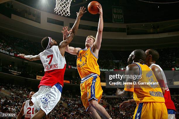 Troy Murphy of the Golden State Warriors lays one up against John Salmons of the Philadelphia 76ers on March 30, 2004 at the Wachovia Center in...