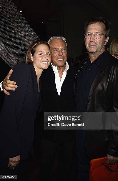 Italian designer Giorgio Armani, American musician Eric Clapton and wife Melia Mcennery attend the cocktail party to celebrate "Giorgio Armani: A...