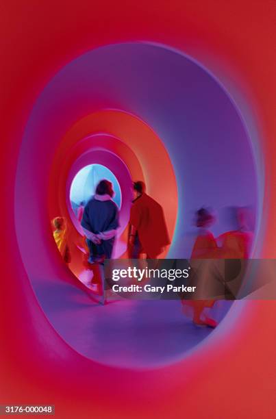 people in purple tunnel - arte contemporaneo fotografías e imágenes de stock