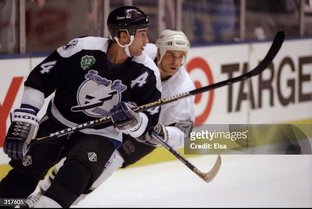 Defenseman Igor Ulanov of the Tampa Bay Lightning in action against leftwinger Craig Johnson of the Los Angeles Kings during a game at the Great...