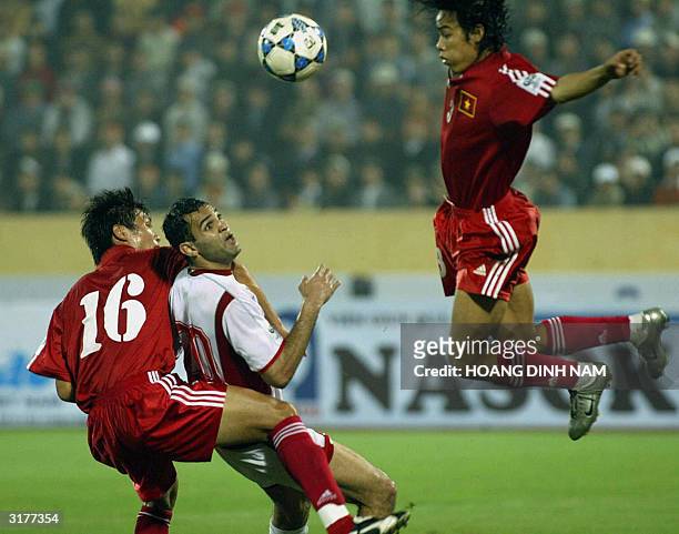Lebanese Rodar Antar fights for the ball with Vietnamese Tran Hai Lam and Nguyen Huy Hoang during a qualyfying football match between Vietnam and...