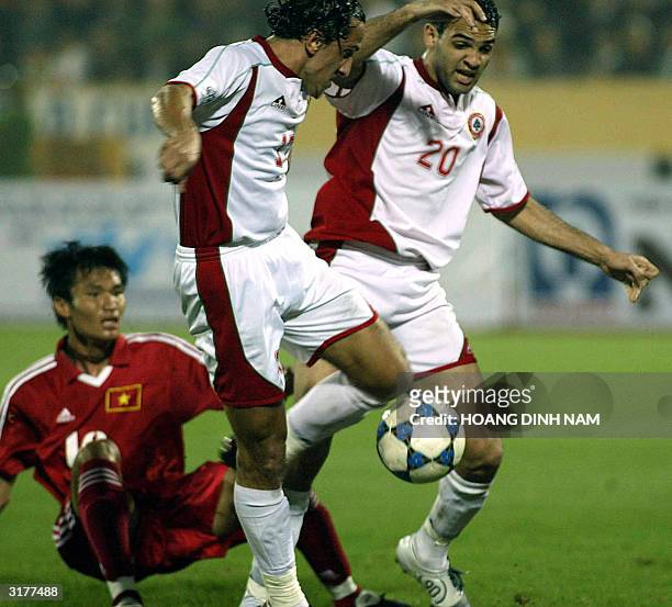 Lebanese Ali Nasseredine and Roda Antar lead an attack through Vietnamese defender Nguyen Huy Hoang during a qualyfying football match between...