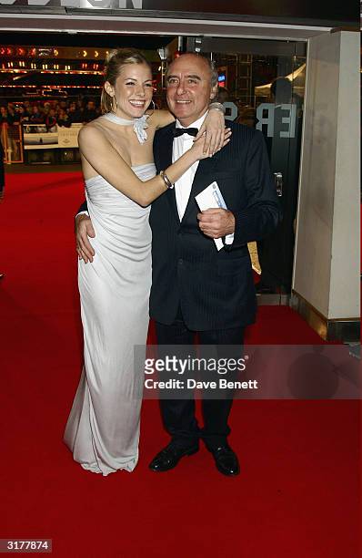 British actor Jude Law's girlfriend Sienna Miller and father arrive at the UK premiere of the fim "Cold Mountain" at the Odeon Cinema Leicester...