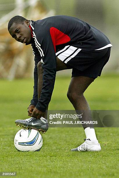 Freddy Adu, the 14-year-old from Ghana who signed with DC United Soccer Club, ties his boot during the first day of team Spring Training in...