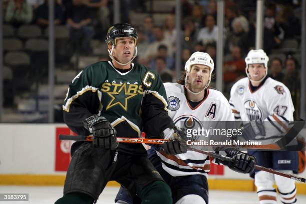 Mike Modano of the Dallas Stars and Ryan Smyth of the Edmonton Oilers skate against each other during play March 31, 2004 at the American Airlines...