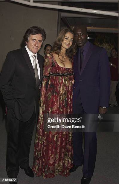 Gabriel Byrne and Oswald Boetang and wife attend the 2003 Lycra British Style Awards at Old Billinsgate Market on September 26, 2003 in London.