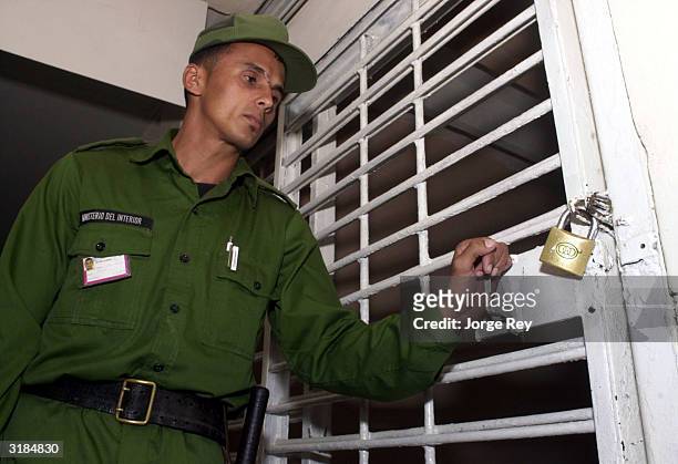 Security guard opens the door of a cell at Prision de Mujeres Occidente, a women's prison in Havana, March 31, 2004 Havana, Cuba. The Cuban...