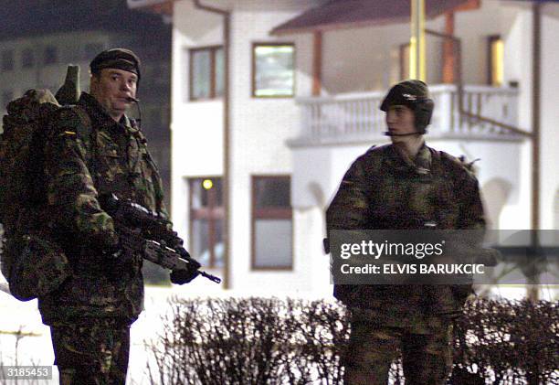 British soldiers, members of the NATO led peacekeeping forces in Bosnia, secure the perimeter after special forces entered a house in Pale, east of...