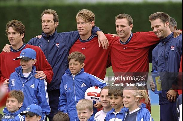 Team captain Thomas Dooley and other members of team USA pose for a portrait with a group of children during the World Cup trainning at the Stade De...
