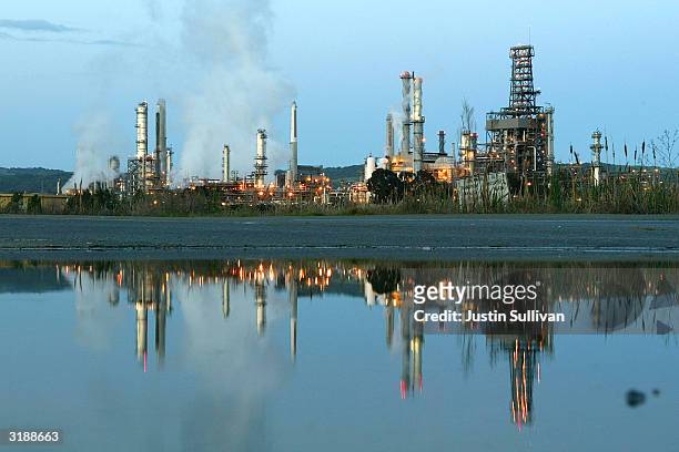 Smoke drifts away from a Shell Oil refinery April 1, 2004 in Martinez, California. Analysts predict that OPEC's decision to cut its oil output target...
