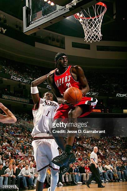 Darius Miles of the Portland Trail Blazers grabs a rebound against Samuel Dalembert of the Philadelphia 76ers on April 1, 2004 at the Wachovia Center...