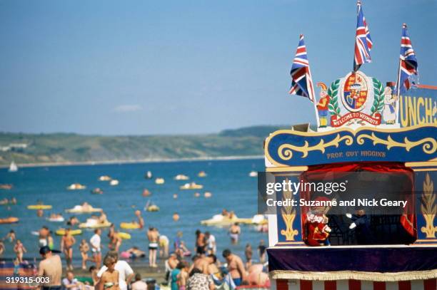 punch and judy show in progress, beach beyond,dorset,england - puppet show stock pictures, royalty-free photos & images