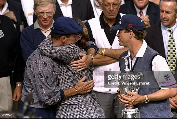 Payne Stewart of the USA hugs Beverly Janzen as Lee Janzen looks on during the 1998 U.S. Open Championships on the 6,797-yard, par-70 Lake Course at...