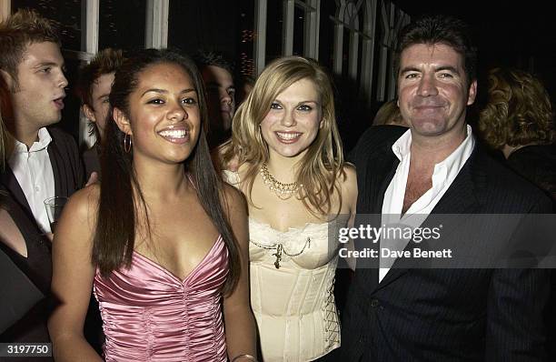 British "Pop Idol" judge Simon Cowell and contestants attend the after-party for the UK premiere of the film "Love Actually" held at the "In and Out...