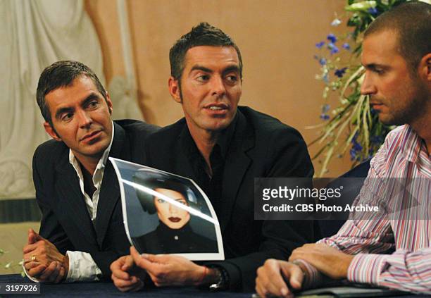 Left to right, fashion designers Dan and Dean Caten of DSquared, along with British fashion photographer Nigel Barker discuss a photograph of Yoanna...
