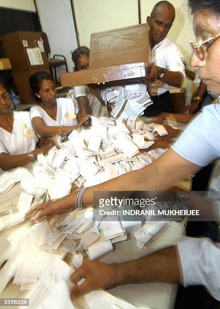 Sri Lankan election official empties a ballot box on a counting table at the D S Senanayke College counting centre in Colombo,02 April 2004. Counting...