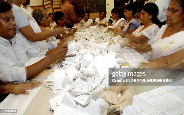 Sri Lankan election officials count ballots at the D S Senanayke College counting centre in Colombo, 02 April 2004. Counting got underway in Sri...