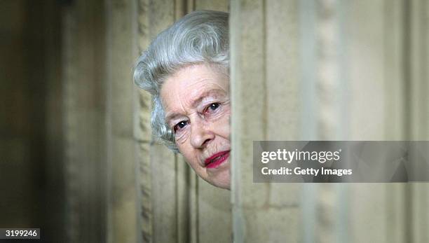 Her Majesty Queen Elizabeth peers round a corner in the newly refurbished Royal Albert Hall on March 30, 2004 in London. The 70m pound development...