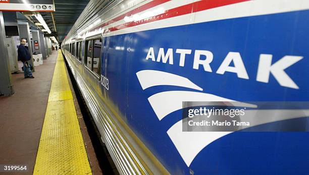 An Amtrak passenger waits for his train at Penn Station April 2, 2004 in New York City. Security officials have received recent threats regarding the...