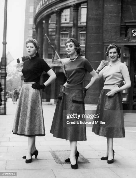 Left to right : Greta Borg, Joy Vergette, and Hazel Prentice, modelling new 'Harella' skirts for the autumn season outside Grosvenor House in London.