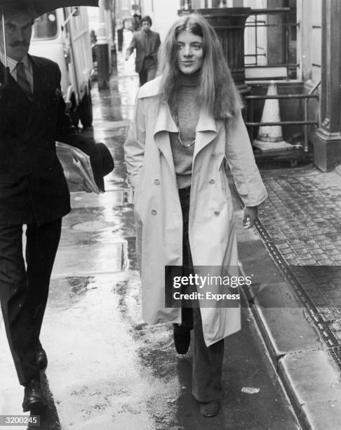 Caroline Kennedy, the daughter of John F. Kennedy and Jacqueline Kennedy Onassis, walking on a rain-soaked street on her way to a course at Sotheby's...