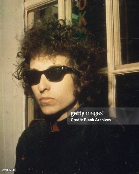 Headshot of American singer Bob Dylan wearing sunglasses, London, England.