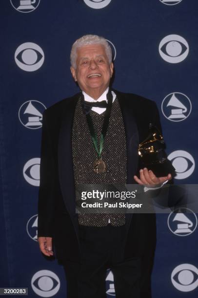 American musician and bandleader Tito Puente holds his Grammy award for Best Traditional Tropical Latin Performance, Staples Center, Los Angeles,...