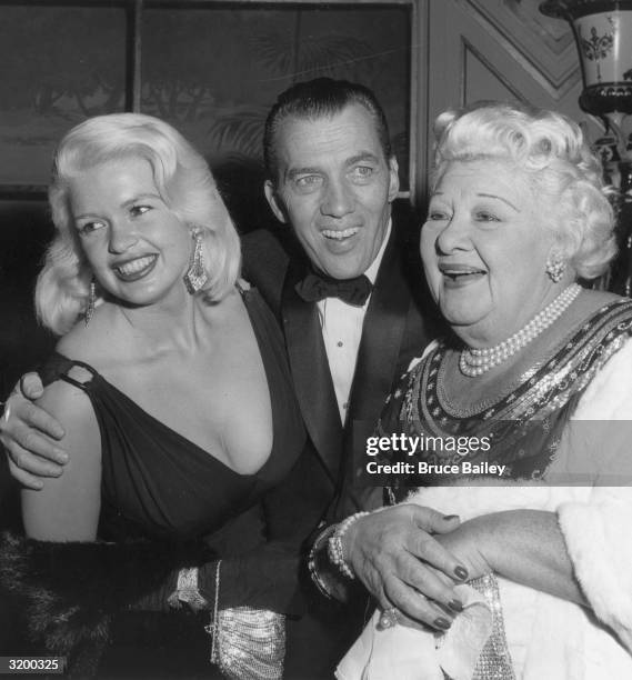 American variety show host Ed Sullivan stands with his arms around American actor Jayne Mansfield and American singer Sophie Tucker, at the Golden...