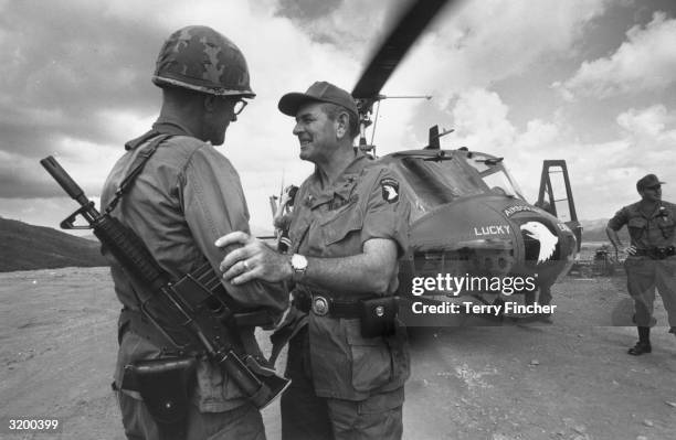 General Melvin Zais , commanding General of the 101st United States Airbourne Division greets a fellow American soldier.