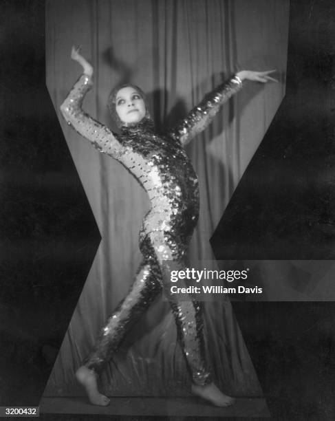 Dancer wearing a sequinned catsuit on stage at the Eve nightclub, Place Pigalle, Paris.