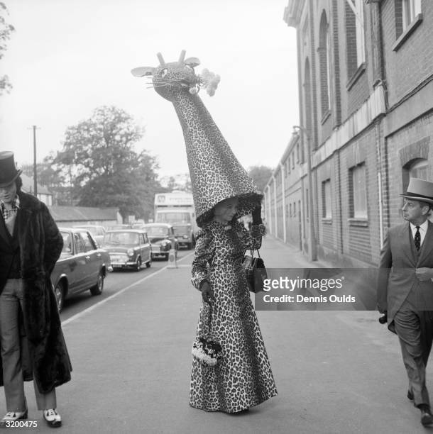Gertrude Shilling, mother of hat designer and milliner David Shilling, with one of her son's characteristically flamboyant hats which she wears...