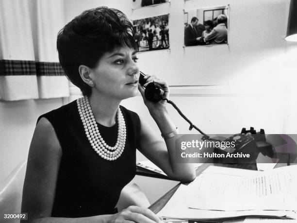 Television journalist for NBC Barbara Walters takes a phone call at her desk, New York City.