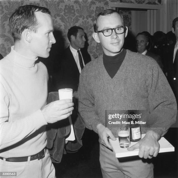 Brothers Dick and Tom Smothers of the American comedy team the Smothers Brothers drink beer at an ABC party for Emmy nominees, Beverly Hills Hotel,...