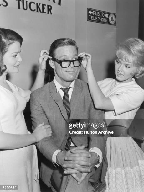 Actors Joan Blackman and Joey Heatherton adjust American actor Richard Chamberlain's eyeglasses, as they promote director Boris Sagal's film,...