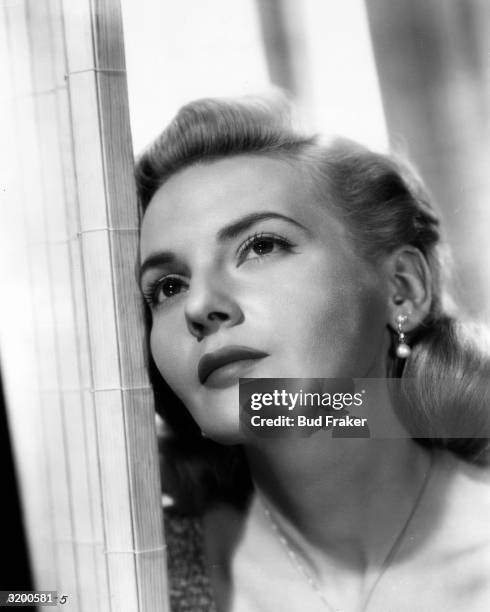 Headshot of British actor Elaine Aiken leaning against a doorframe.