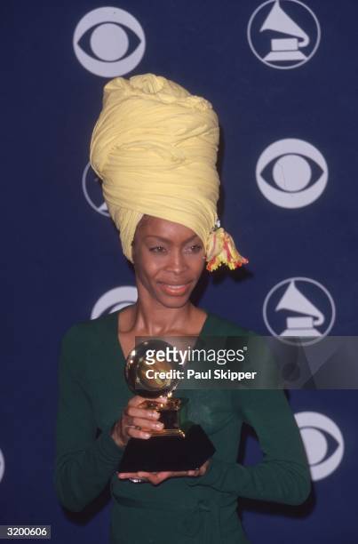 American singer Erykah Badu holds her Grammy award for Best Rap Performance by a Duo or Group, won for the song, 'You Got Me,' a collaboration with...